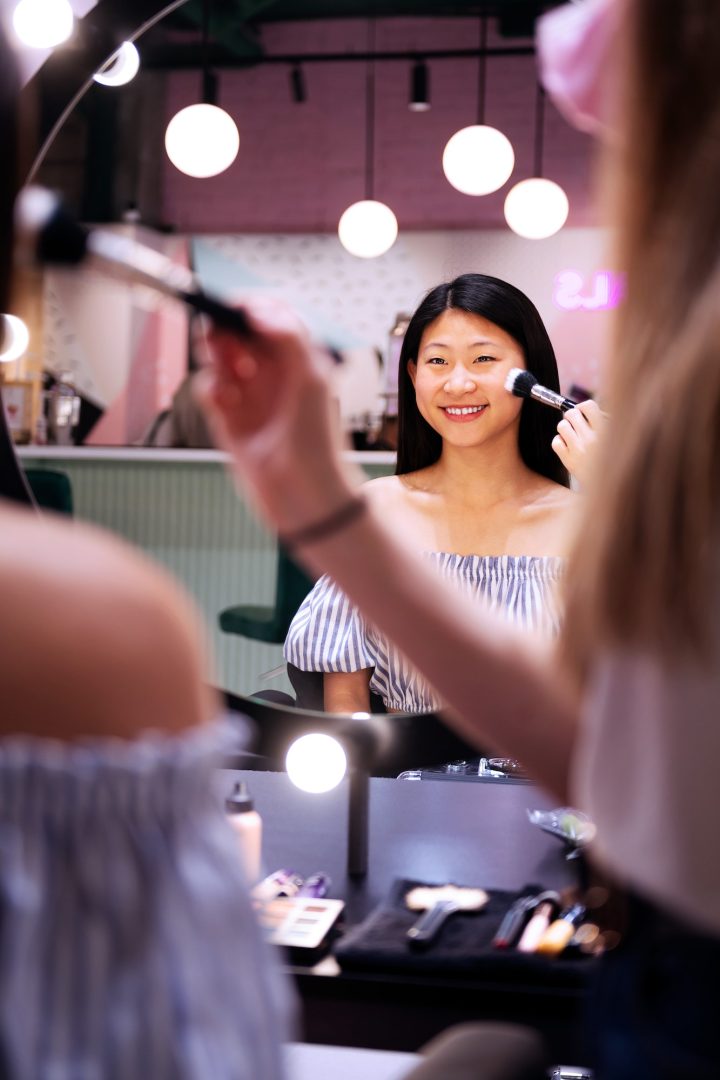 makeup artist applying make-up to a woman