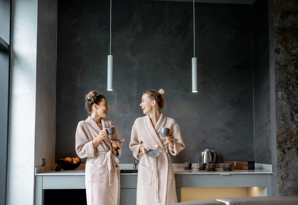 Women in bathrobes relaxing on the kitchen